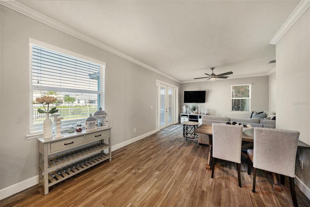 6412 Key Island Boulevard Apollo Beach, FL 33572 - Photo 12 of 42 a living room with furniture a flat screen tv and wooden floor