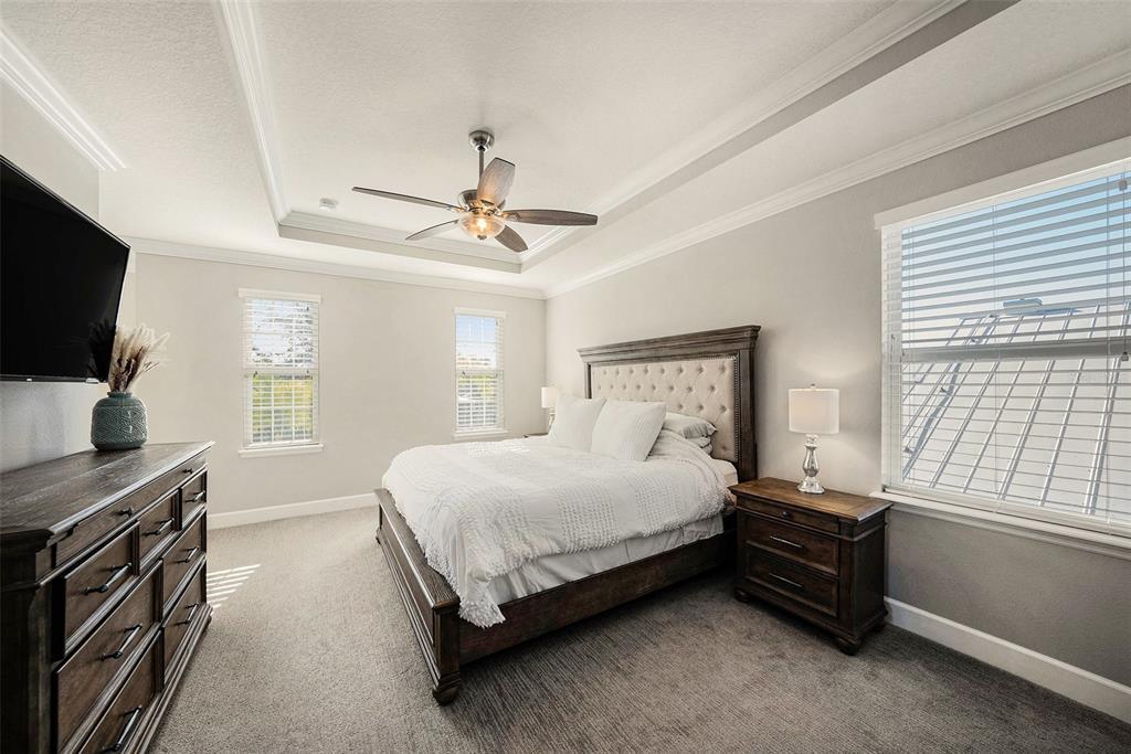 6412 Key Island Boulevard Apollo Beach, FL 33572 - Photo 15 of 42 a bedroom with a bed and a flat screen tv on the dresser