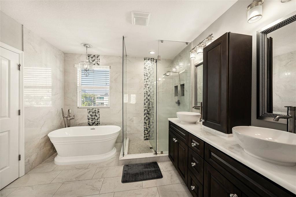 6412 Key Island Boulevard Apollo Beach, FL 33572 - Photo 19 of 42 a bathroom with a double vanity sink a toilet a mirror and shower