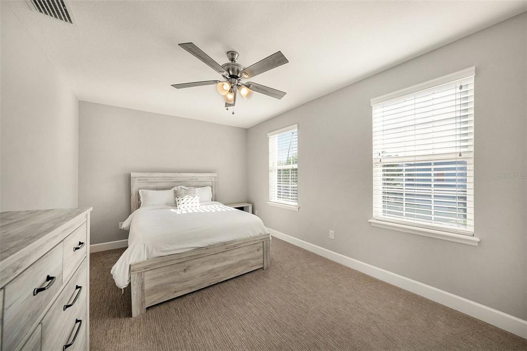 6412 Key Island Boulevard Apollo Beach, FL 33572 - Photo 21 of 42 a bedroom with a bed chandelier and a window
