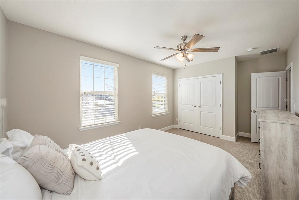 6412 Key Island Boulevard Apollo Beach, FL 33572 - Photo 29 of 42 a bedroom with a bed and a ceiling fan
