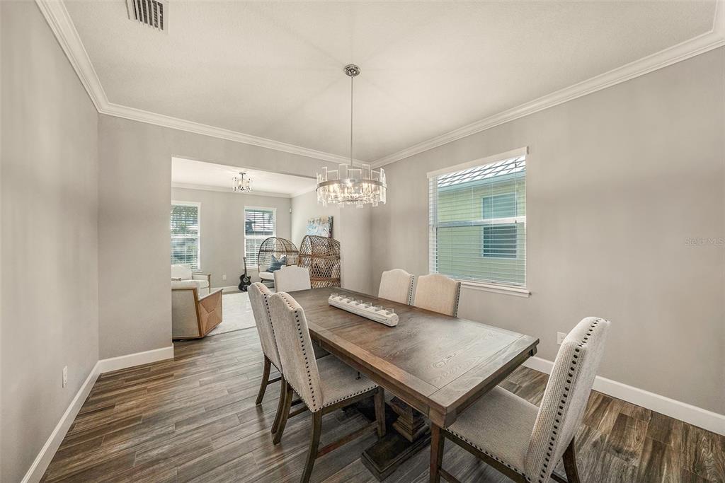 6412 Key Island Boulevard Apollo Beach, FL 33572 - Photo 8 of 42 a view of a dining room with furniture window and wooden floor