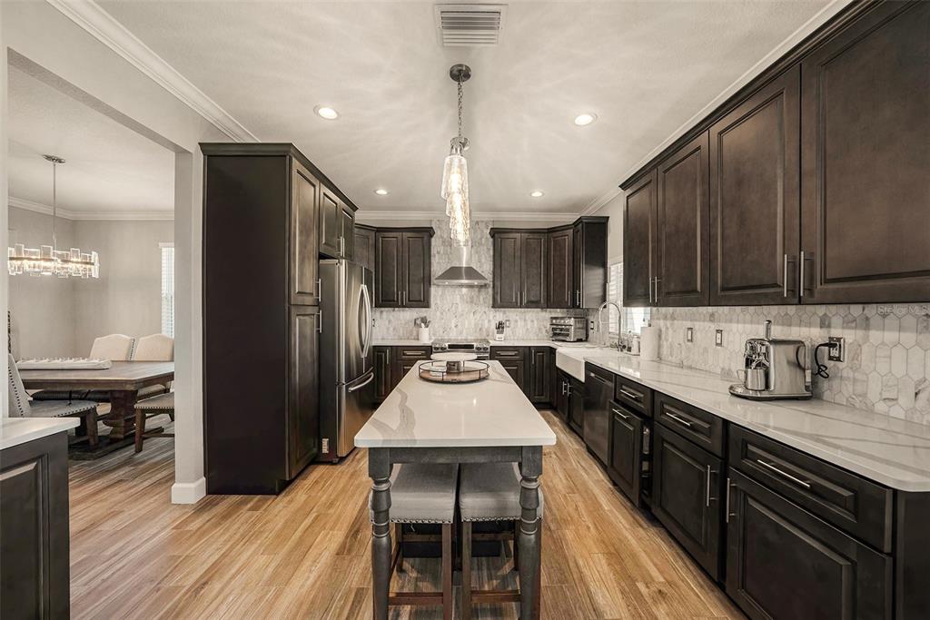 6412 Key Island Boulevard Apollo Beach, FL 33572 - Photo 10 of 42 a kitchen with a sink stove and refrigerator