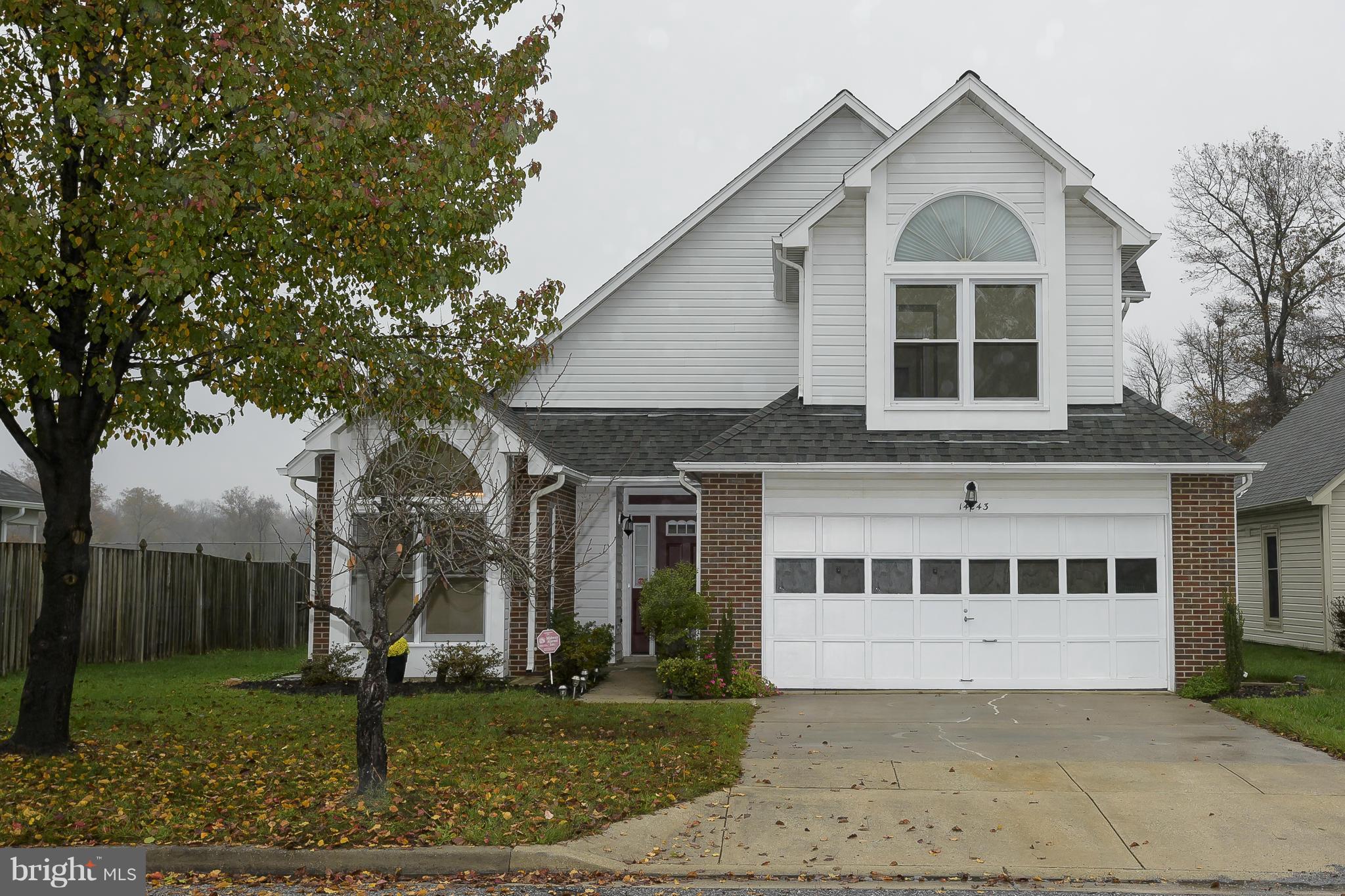 14243 Greenview Drive Laurel, MD 20708 - Photo 1 of 26 a view of a white house next to a yard with big trees