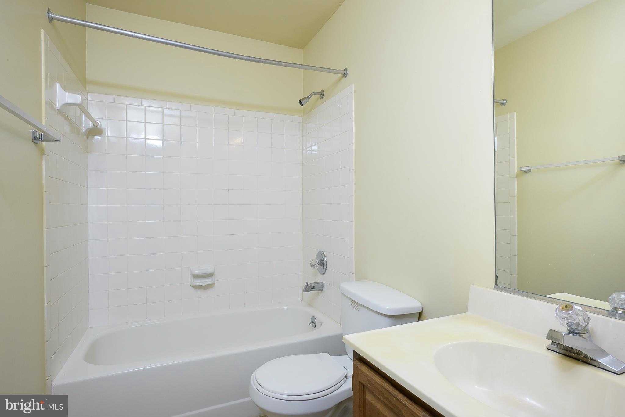 14243 Greenview Drive Laurel, MD 20708 - Photo 19 of 26 a bathroom with a sink toilet and shower