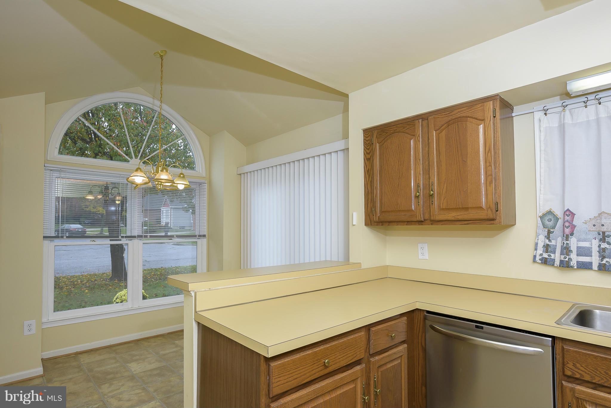 14243 Greenview Drive Laurel, MD 20708 - Photo 8 of 26 a kitchen with a sink and a refrigerator