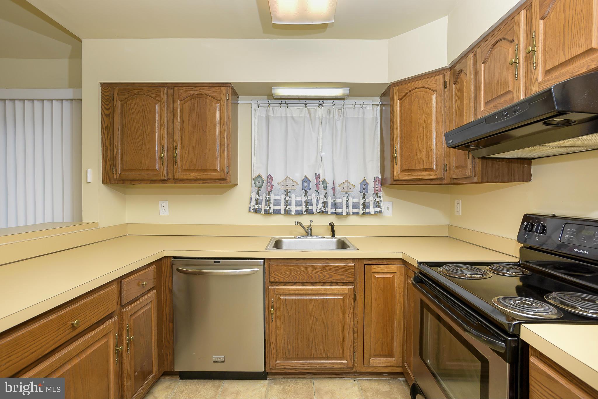 14243 Greenview Drive Laurel, MD 20708 - Photo 9 of 26 a kitchen with stainless steel appliances granite countertop a sink stove and cabinets