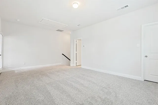 an empty room with a ceiling fan and a window