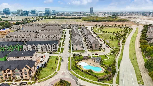 a view of a swimming pool with outdoor seating and city view