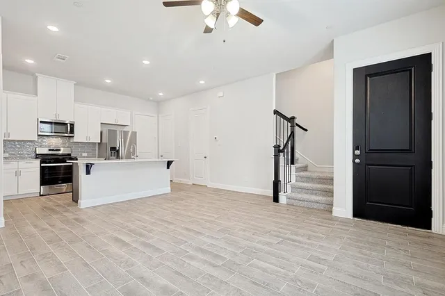 a view of kitchen with sink microwave and refrigerator