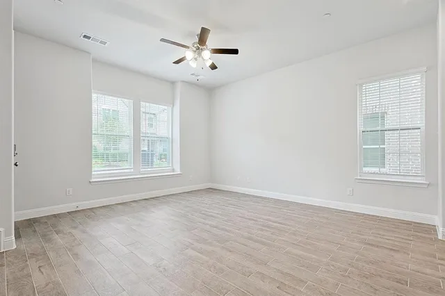 wooden floor in an empty room with a window