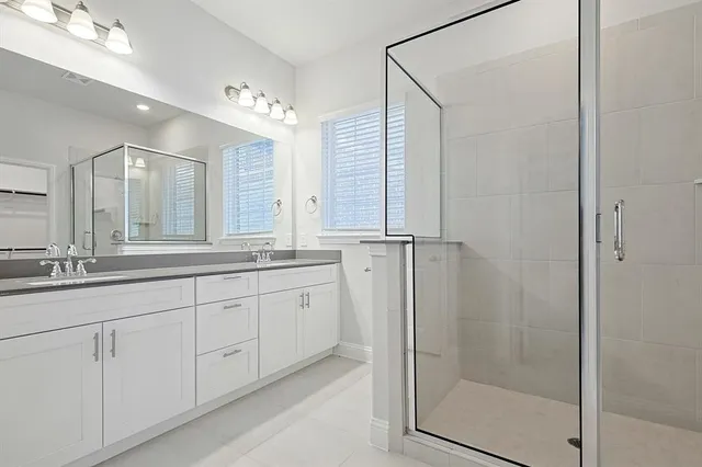 a bathroom with double sink and a mirror