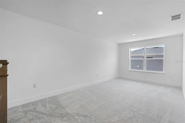 a view of a livingroom with a dishwasher and a refrigerator with wooden floor
