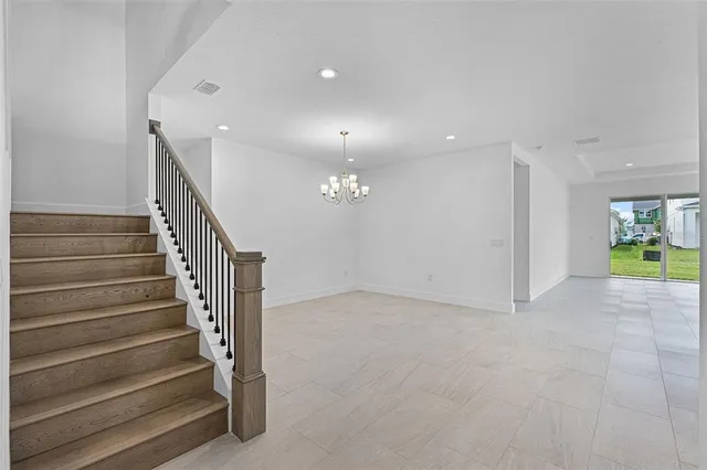 a view of an room with wooden floor and stairs