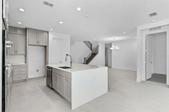 a kitchen with a sink and a refrigerator