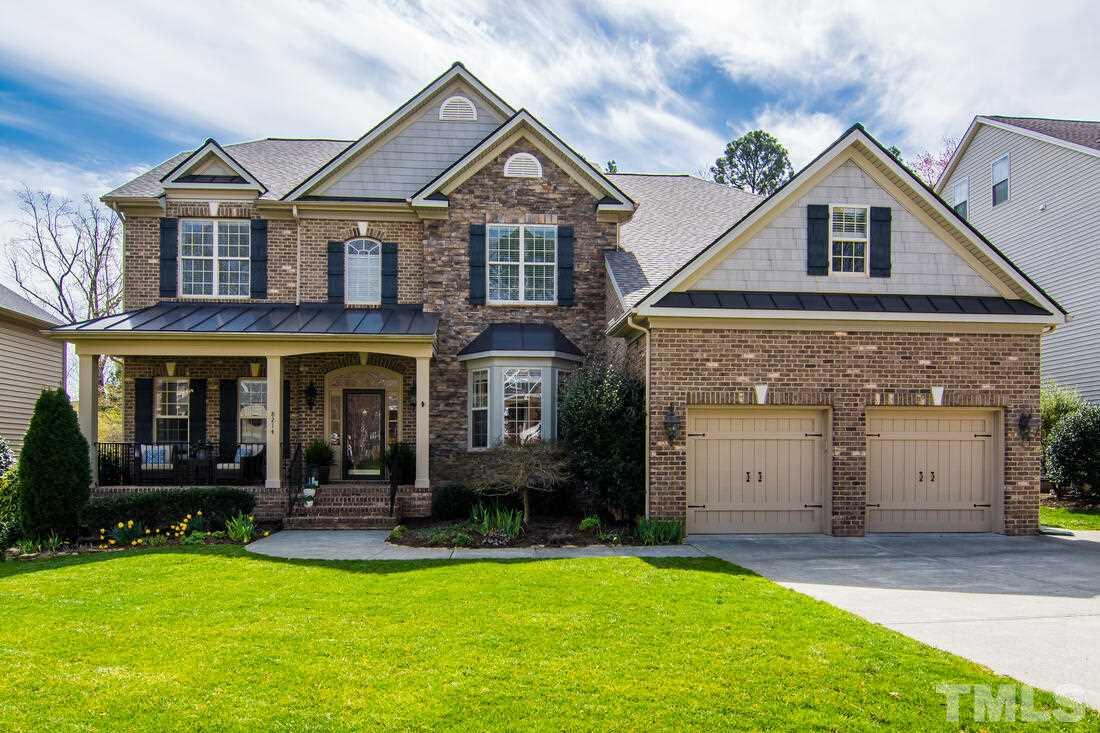 8214 Cushing Street Raleigh, NC 27613 - Photo 1 of 30 a front view of a house with garden
