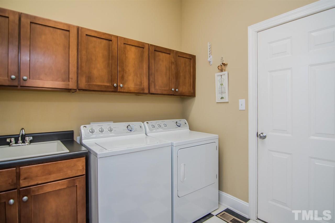 8214 Cushing Street Raleigh, NC 27613 - Photo 12 of 30 a utility room with dryer and washer