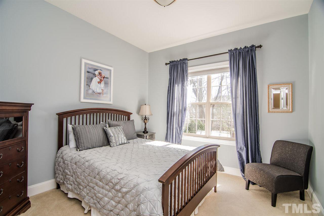 8214 Cushing Street Raleigh, NC 27613 - Photo 13 of 30 a bedroom with a bed and a window