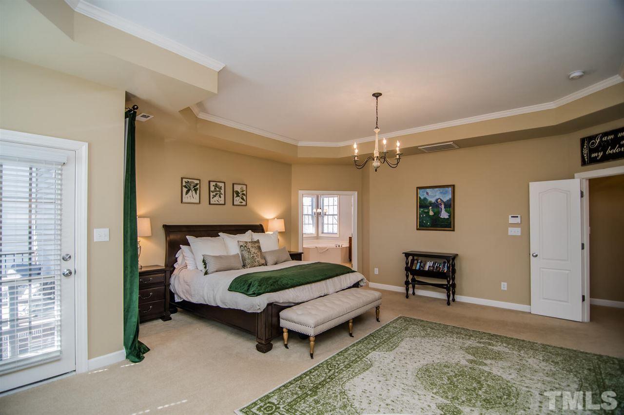 8214 Cushing Street Raleigh, NC 27613 - Photo 16 of 30 a bedroom with a bed dresser and a window