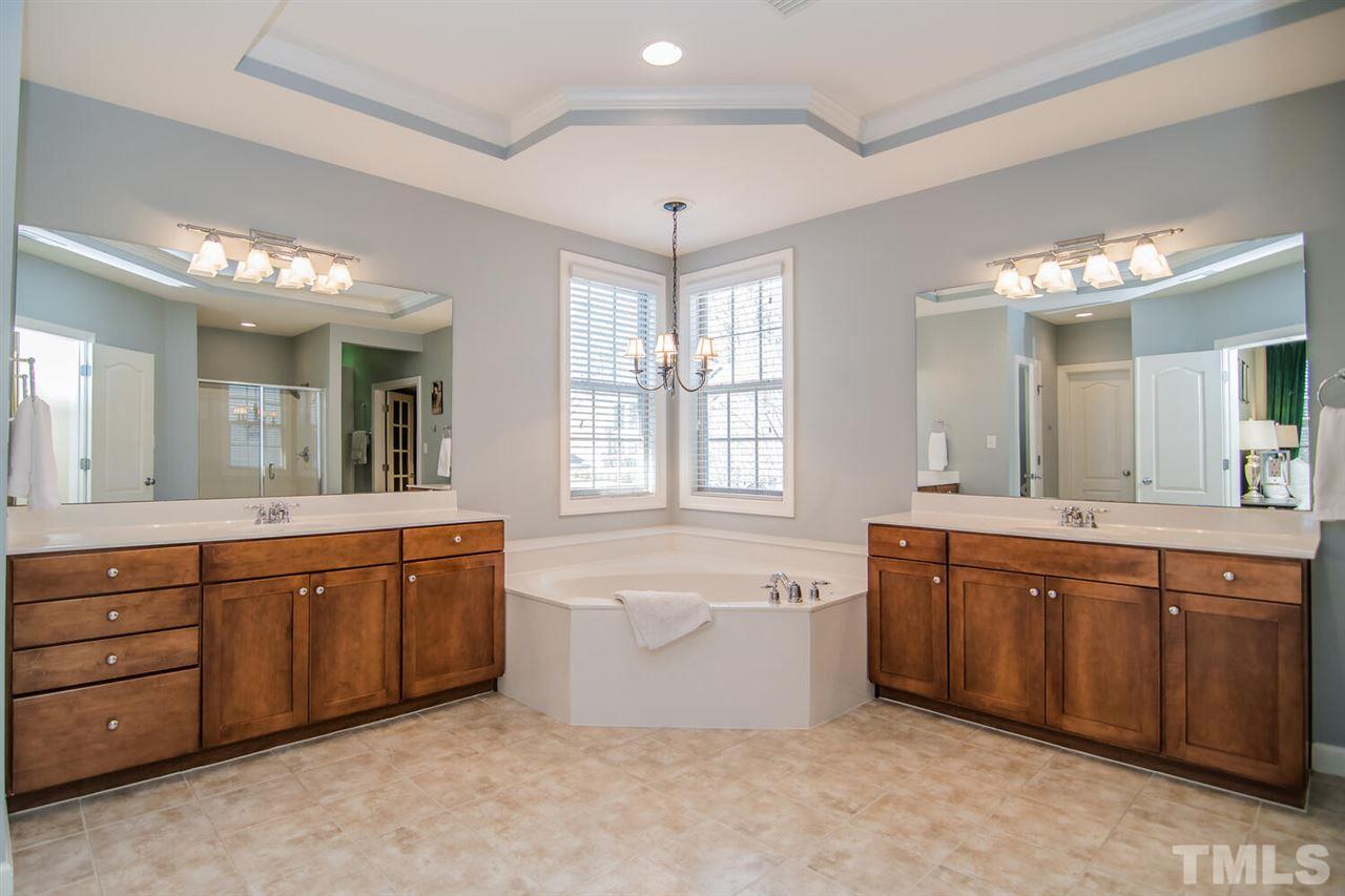8214 Cushing Street Raleigh, NC 27613 - Photo 18 of 30 a large bathroom with a large tub and sink