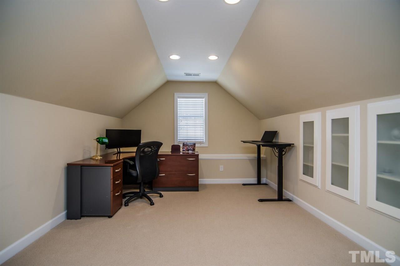 8214 Cushing Street Raleigh, NC 27613 - Photo 21 of 30 a view of a livingroom with a workspace