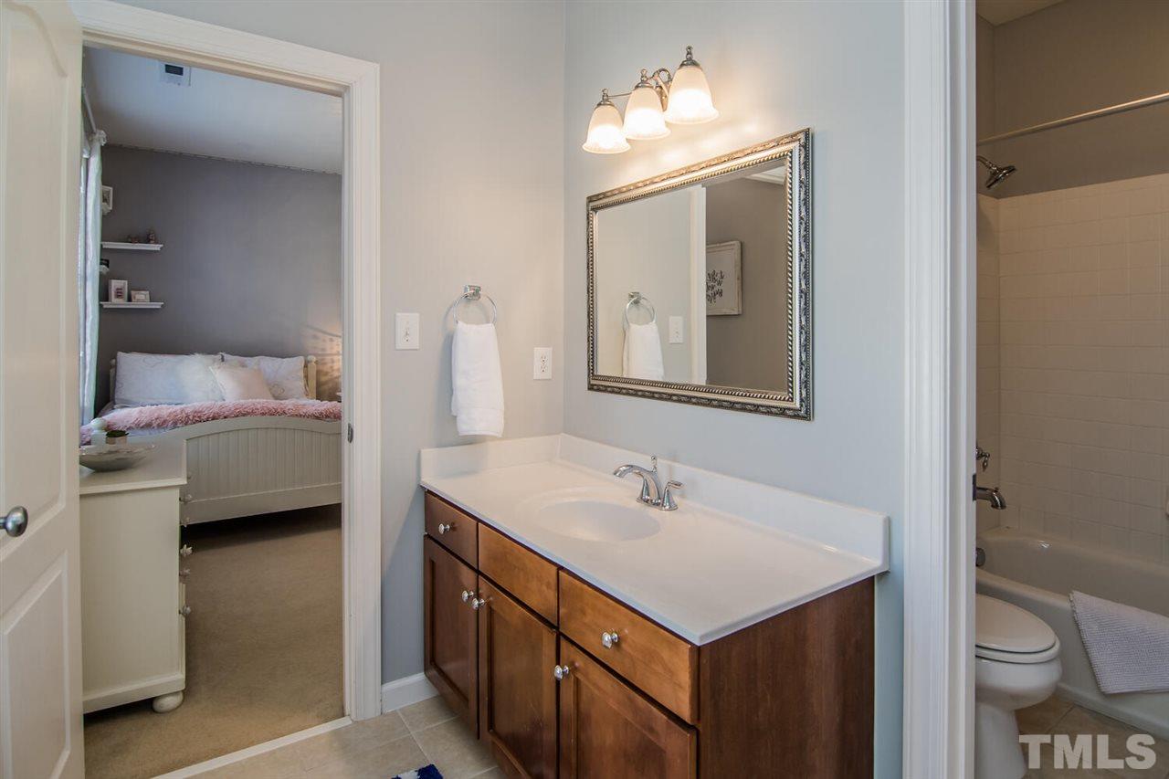 8214 Cushing Street Raleigh, NC 27613 - Photo 24 of 30 a en suite bathroom with a toilet sink and mirror