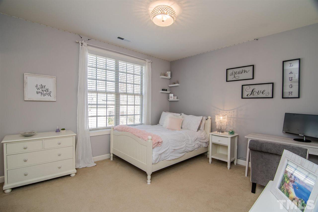 8214 Cushing Street Raleigh, NC 27613 - Photo 25 of 30 a bedroom with a bed and a window