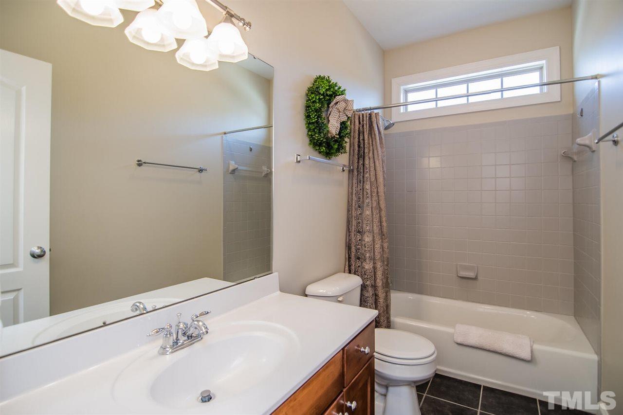 8214 Cushing Street Raleigh, NC 27613 - Photo 27 of 30 a bathroom with a sink toilet and shower