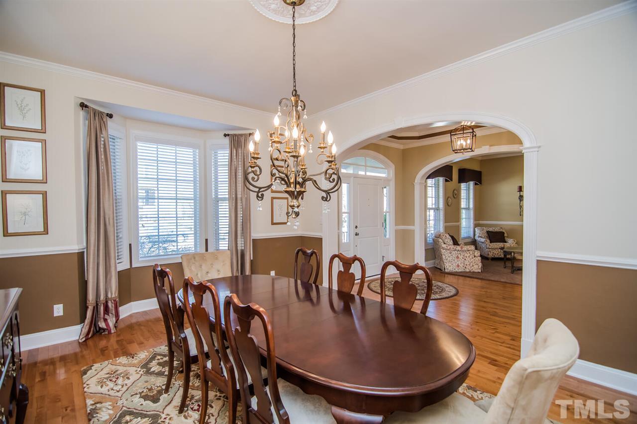 8214 Cushing Street Raleigh, NC 27613 - Photo 4 of 30 a view of a dining room with furniture and chandelier