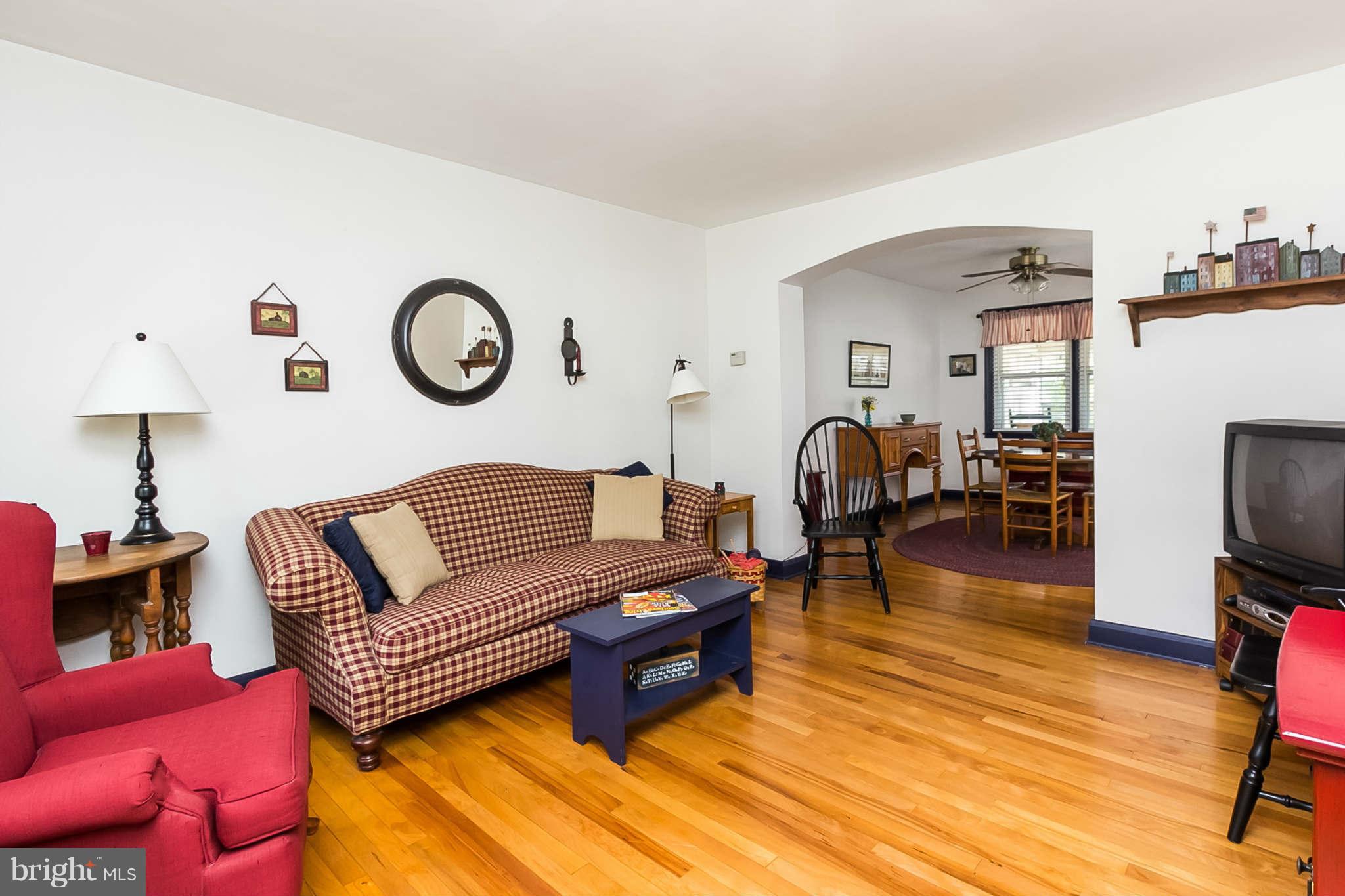 8315 Bon Air Road Baltimore, MD 21234 - Photo 5 of 25 a living room with furniture a flat screen tv and a fireplace