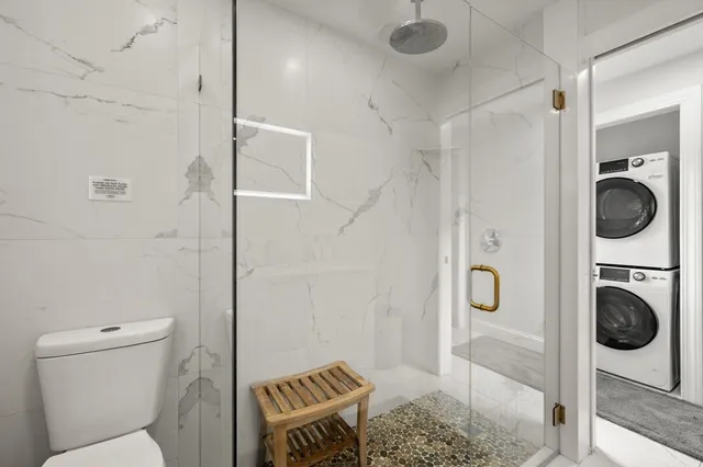 a bathroom with a toilet and a shower