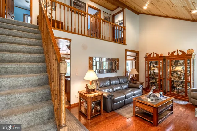 a view of staircase with lots of frames on wall and wooden floor