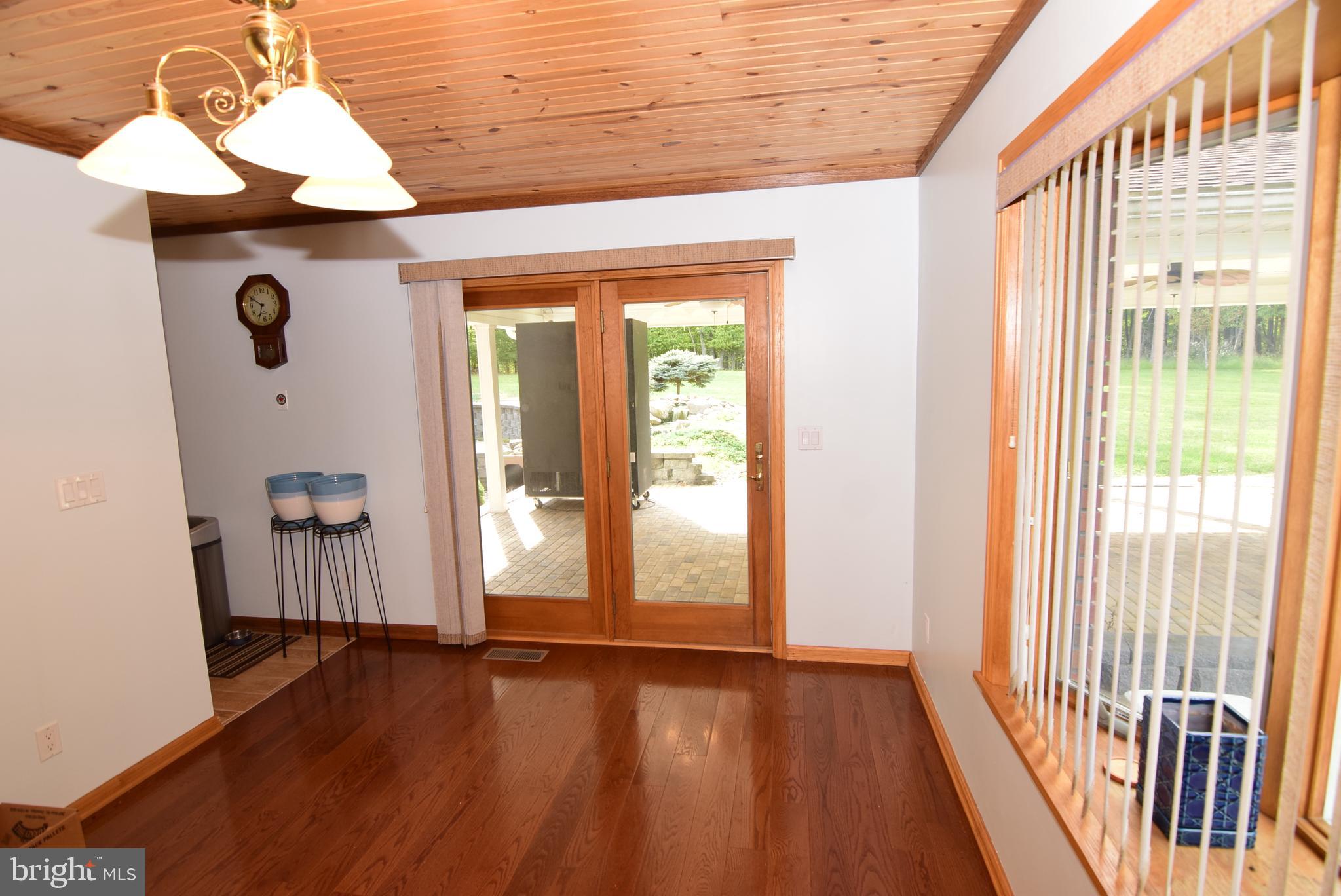 1296 Sunnyside Hollow Road Port Matilda, PA 16870 - Photo 24 of 49 a view of an empty room with wooden floor and a window