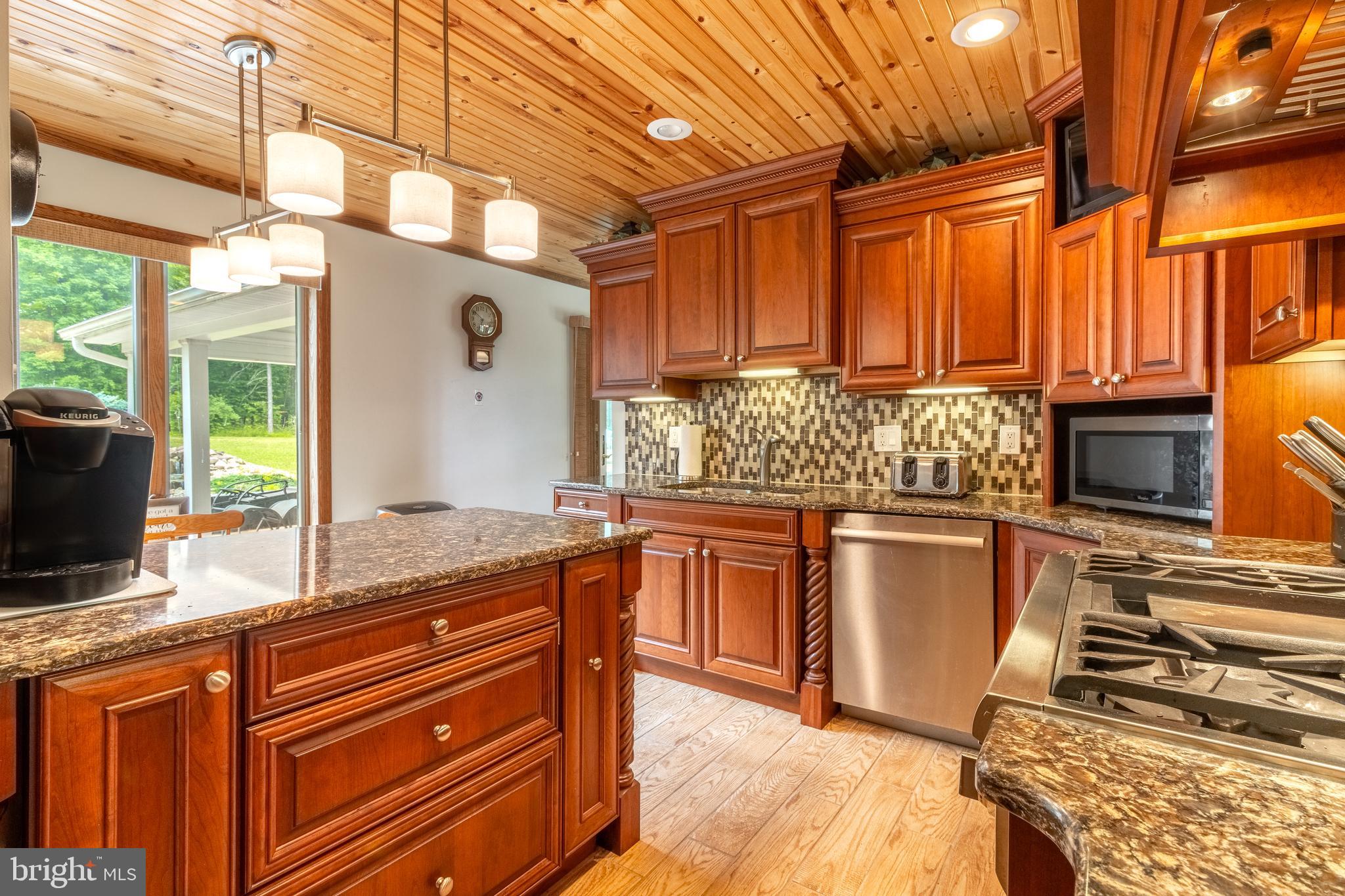 1296 Sunnyside Hollow Road Port Matilda, PA 16870 - Photo 26 of 49 a kitchen with stainless steel appliances granite countertop a stove a sink and a microwave