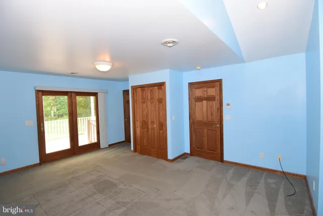 a bedroom with a bed and a lamp on table