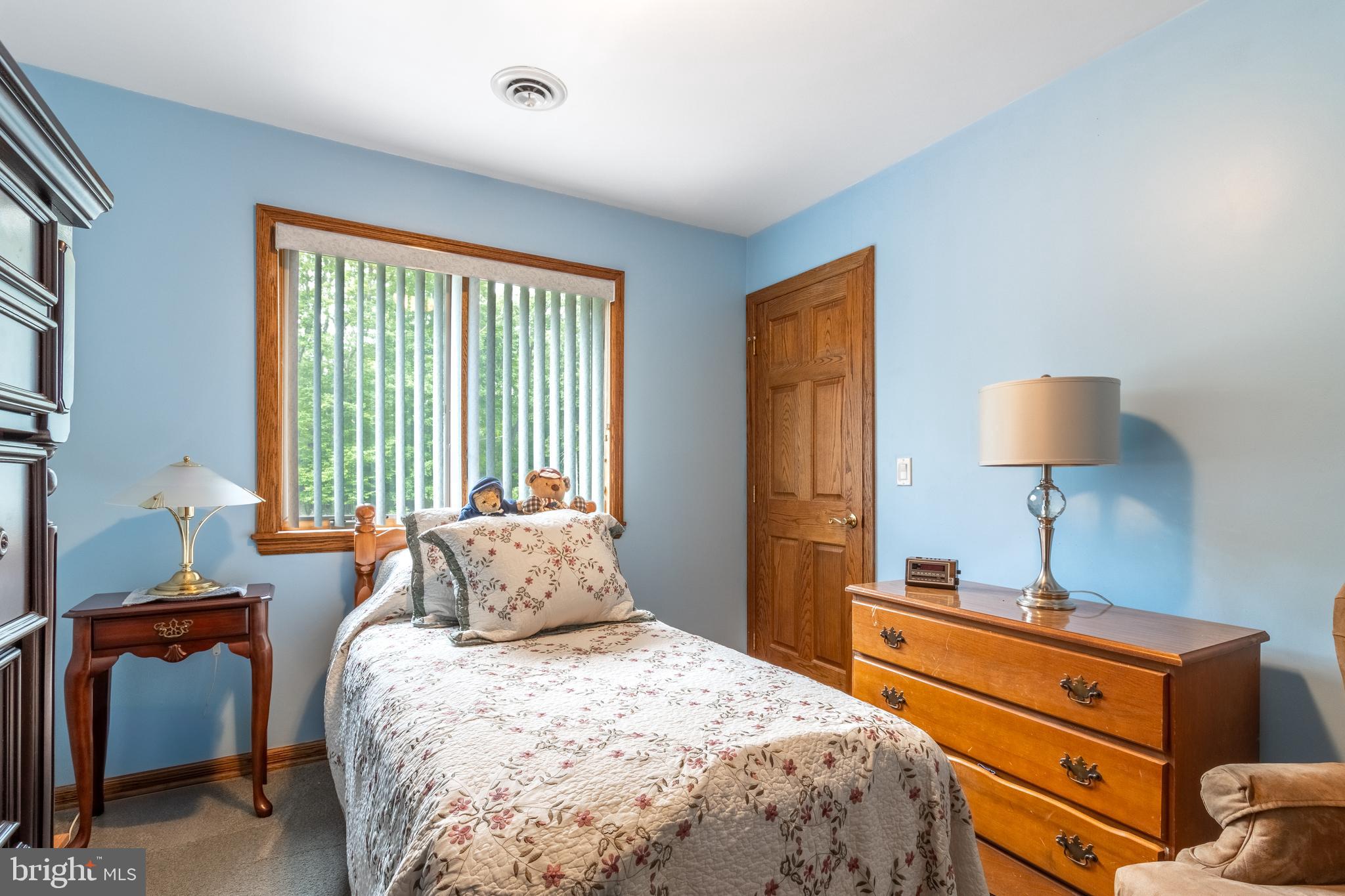 1296 Sunnyside Hollow Road Port Matilda, PA 16870 - Photo 39 of 49 a bedroom with a bed and a lamp on table