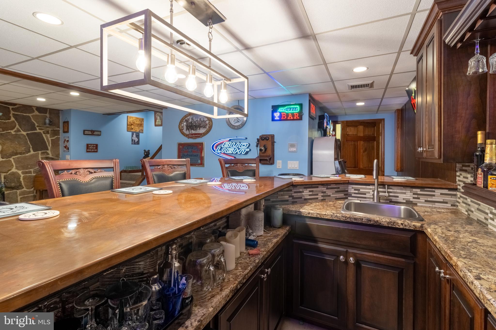 1296 Sunnyside Hollow Road Port Matilda, PA 16870 - Photo 45 of 49 a kitchen with stainless steel appliances granite countertop a sink a stove and a wooden cabinets