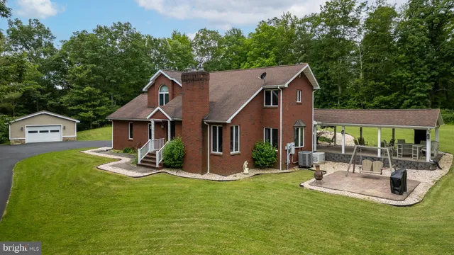 a view of a house with backyard porch and sitting area