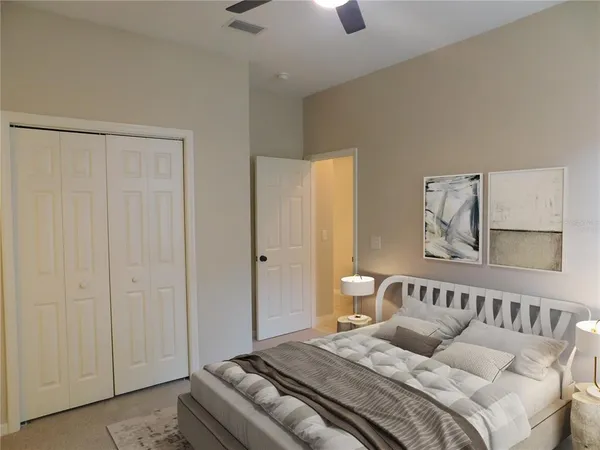 a bedroom with a bed and a chandelier