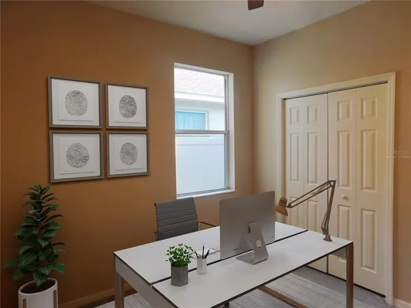 a view of a workspace with furniture and window