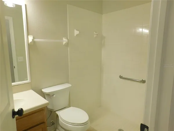 a white toilet sitting next to a bathroom sink