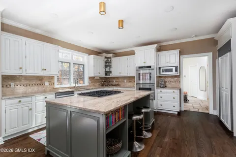 a kitchen with stainless steel appliances a stove refrigerator sink and cabinets