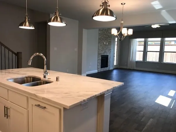 a kitchen with a table chairs and a chandelier