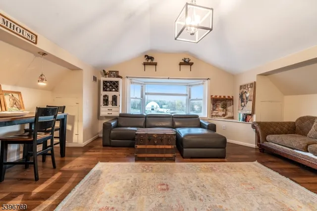a living room with furniture and a chandelier