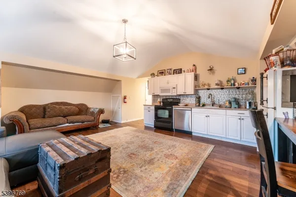 a living room with furniture and kitchen view