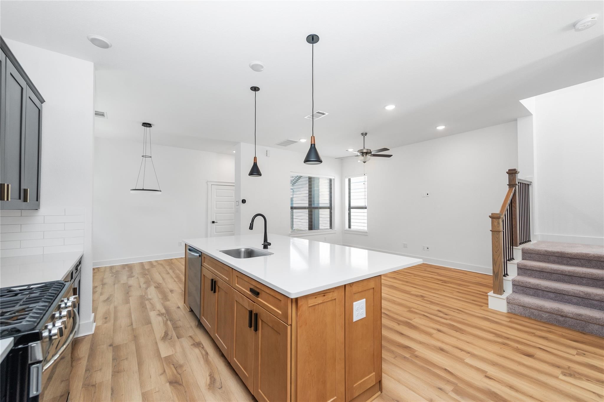18618 Courteous Way Cypress, TX 77433 - Photo 17 of 30 a kitchen with stainless steel appliances granite countertop a sink stove and wooden floor