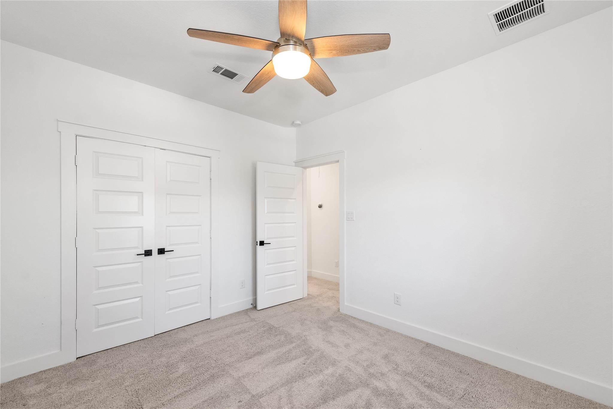 18618 Courteous Way Cypress, TX 77433 - Photo 28 of 30 an empty room with closet and a ceiling fan