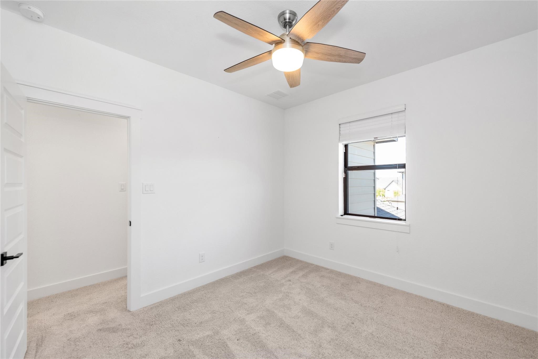 18618 Courteous Way Cypress, TX 77433 - Photo 29 of 30 an empty room with a window and a fan