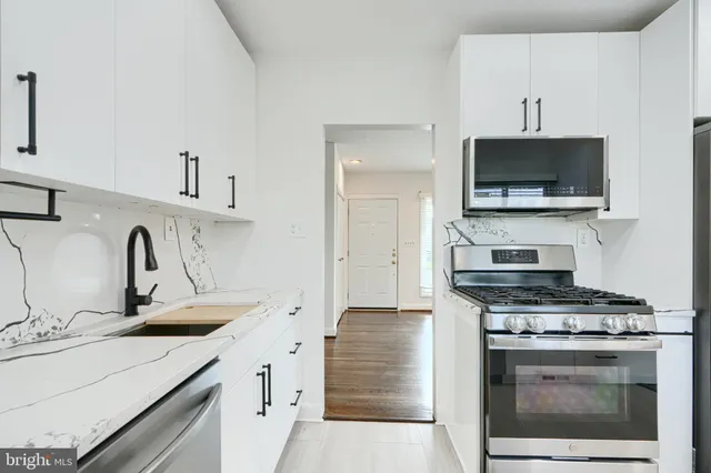 a kitchen with a sink stove and microwave