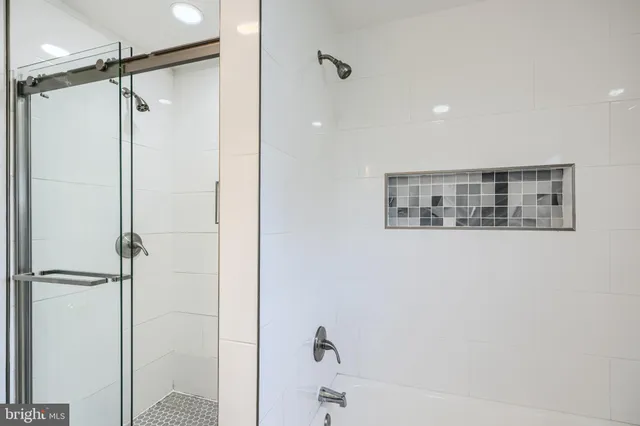 a bathroom with a shower and a glass door